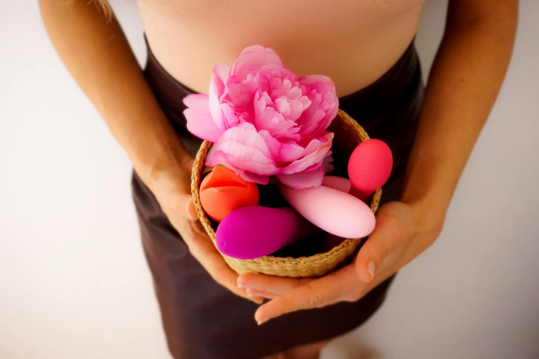 Vibrant display of various sex toys arranged on a bright yellow surface